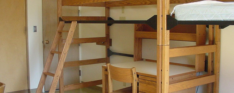 A desk under a lofted bed in a Nash double room