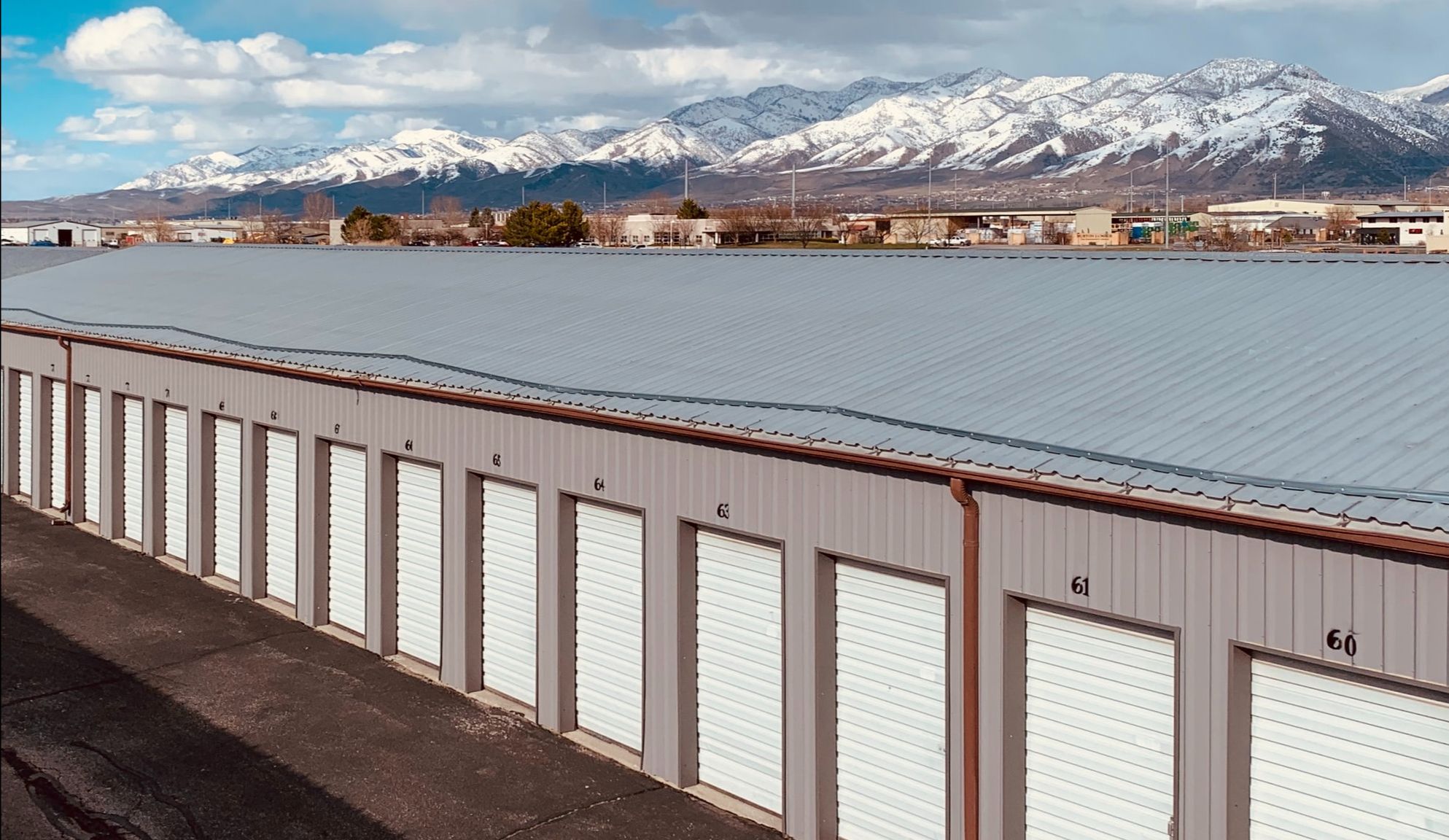 A row of storage units with snowy mountains in the background