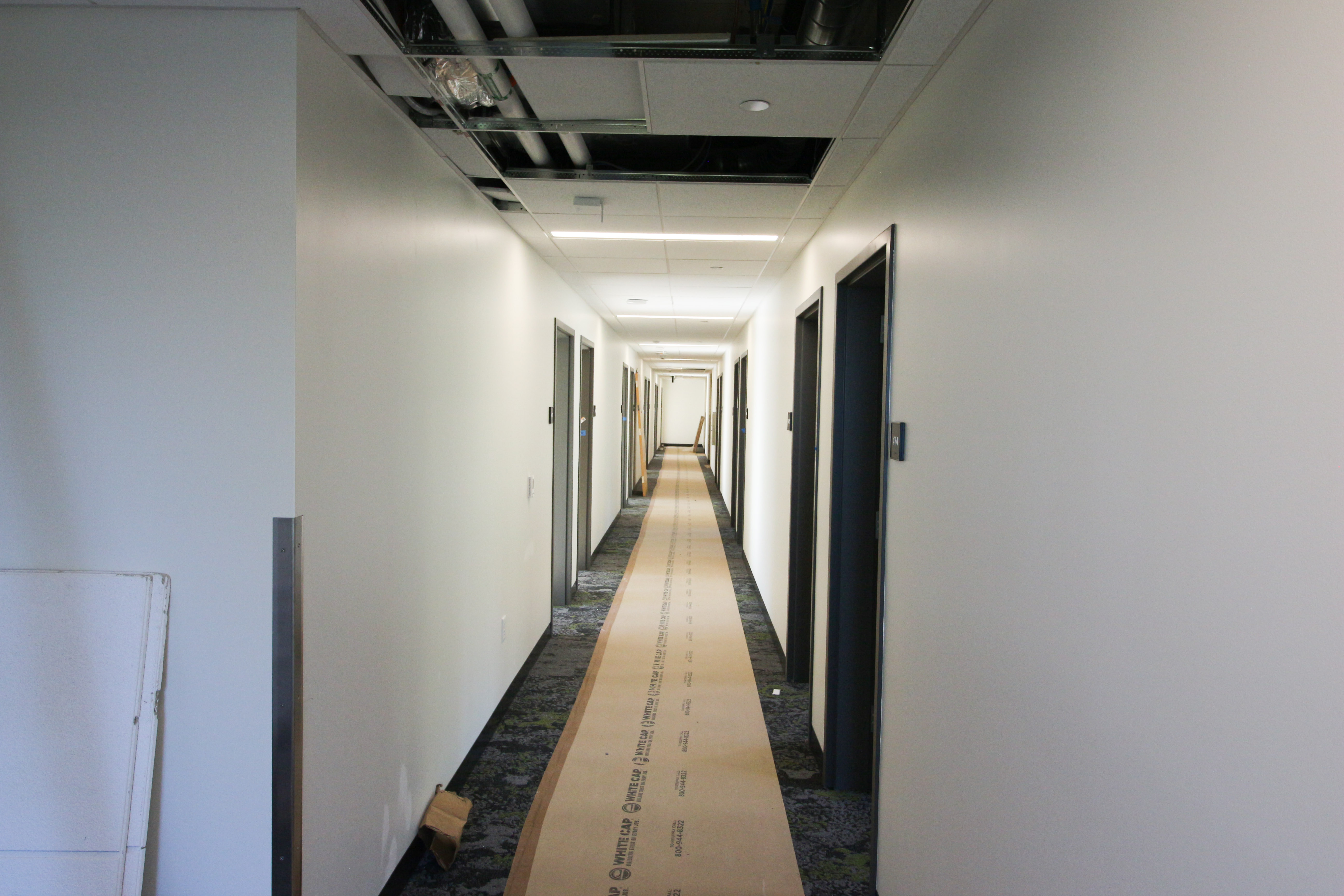 Residential hallway with doors to student rooms on both sides