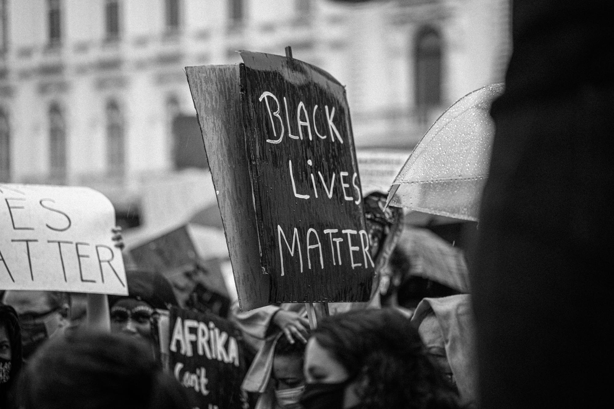 A black and white photo of a sign reading "Black Lives Matter"