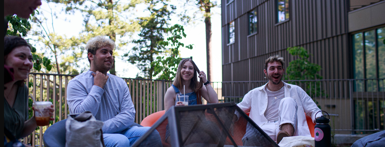 Students hanging out at outdoor lounge in Alma Clark Glass