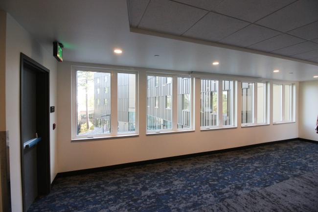 Common area with windows lining the wall