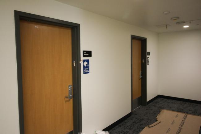 Short hallway with doors to gender-neutral bathrooms