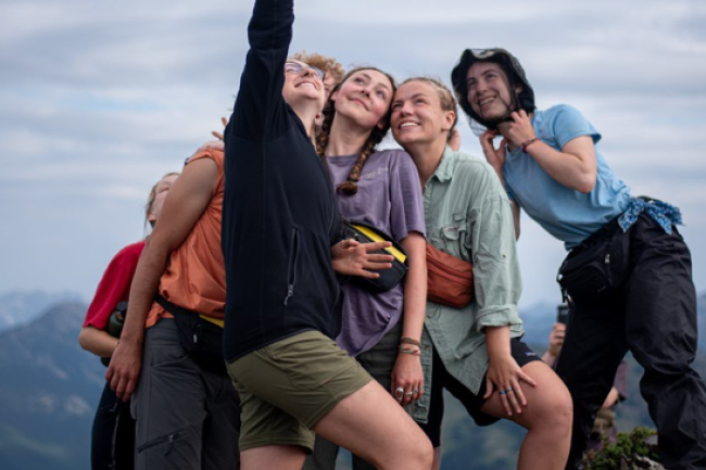 Students taking a group selfie on a class hike